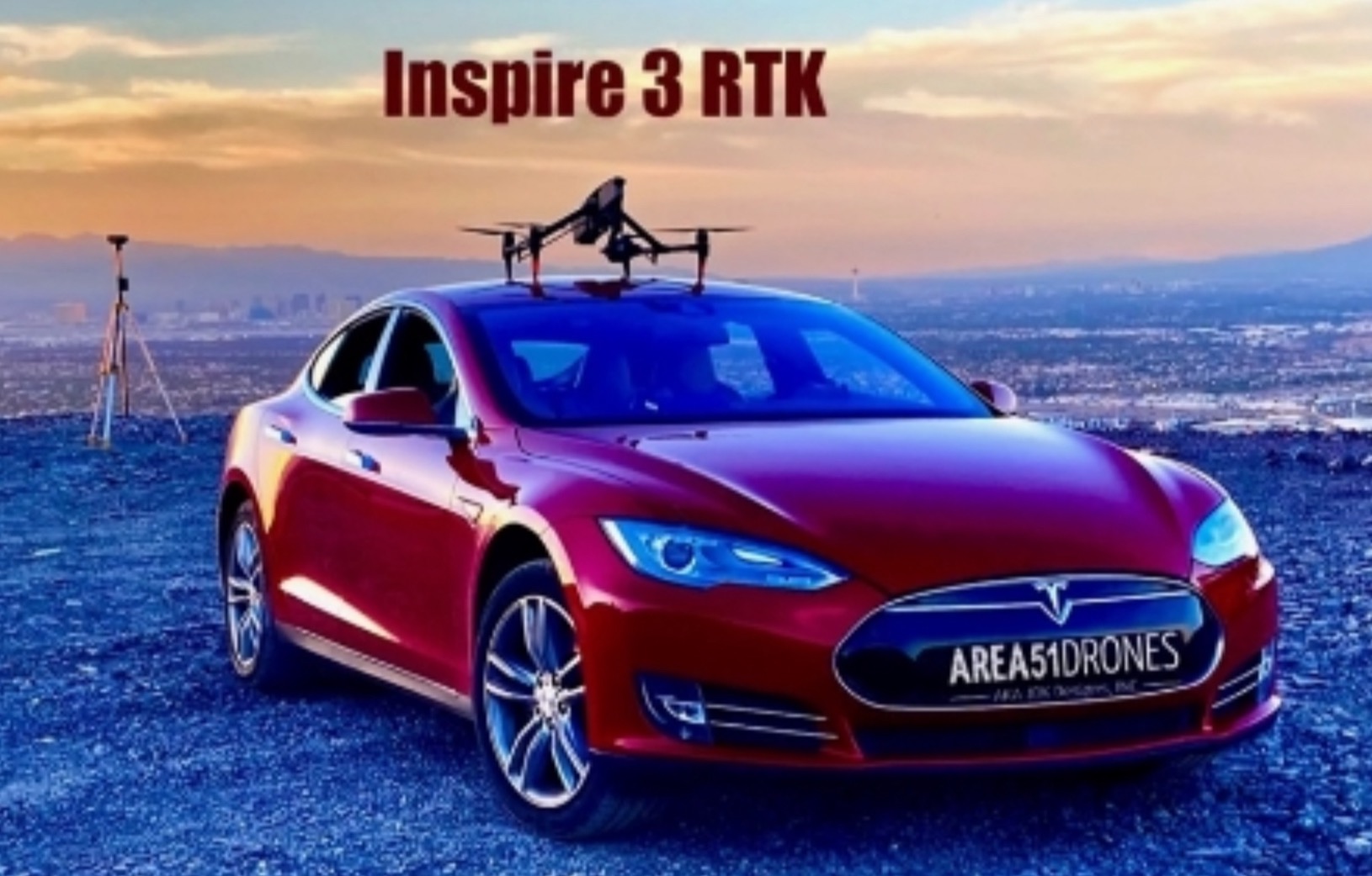 Area 51 Drones red Tesla with a DJI Inspire 3 on the roof and an RTK base station on a tripod behind the car, at left.