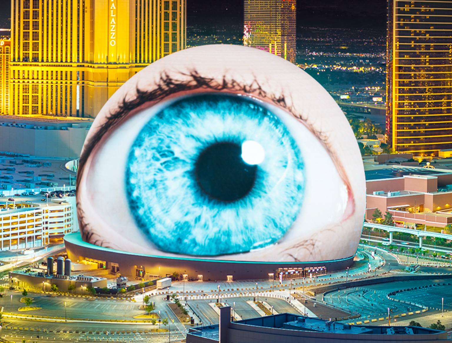 Sphere displaying a vivid blue eye against the Las Vegas skyline at night.